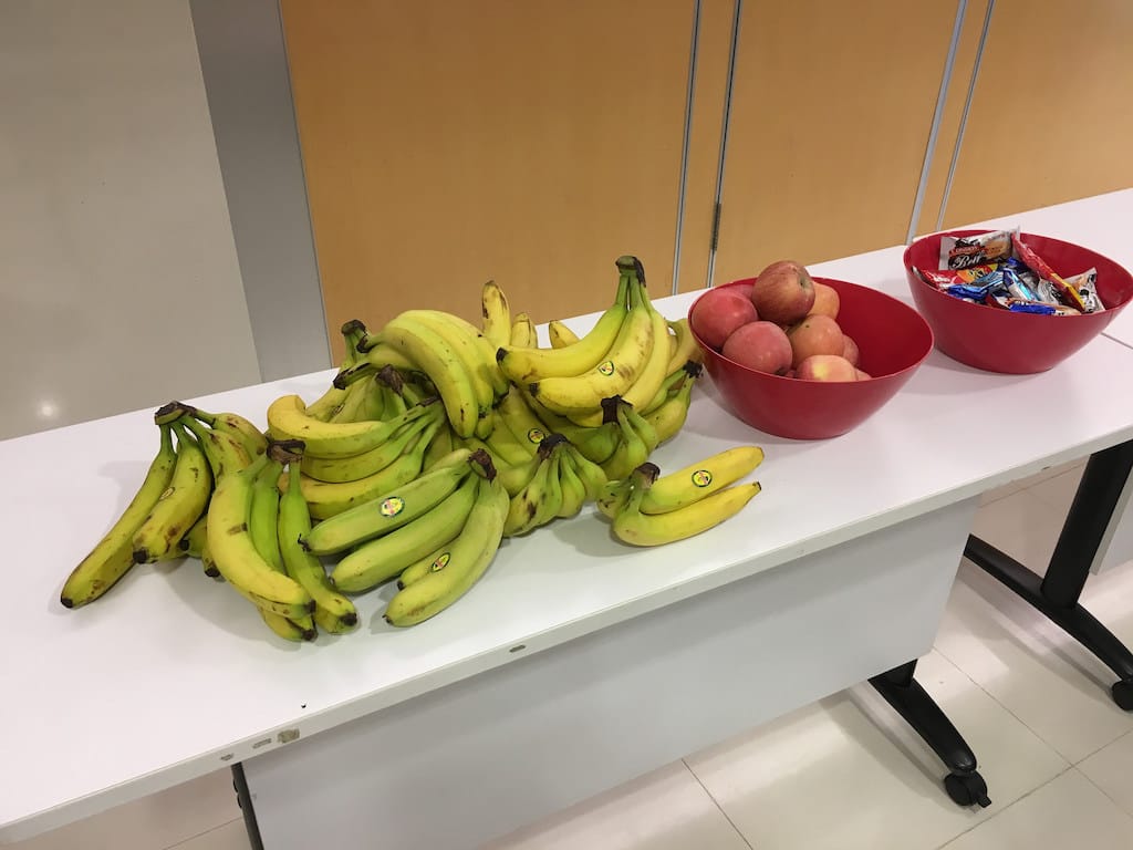 Banana, apple and snacks on a table at Webconf.Asia