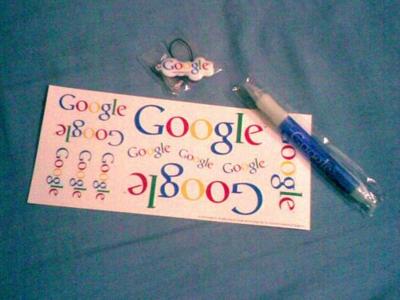 Google goodies, including a pen, stickers and some badge thing