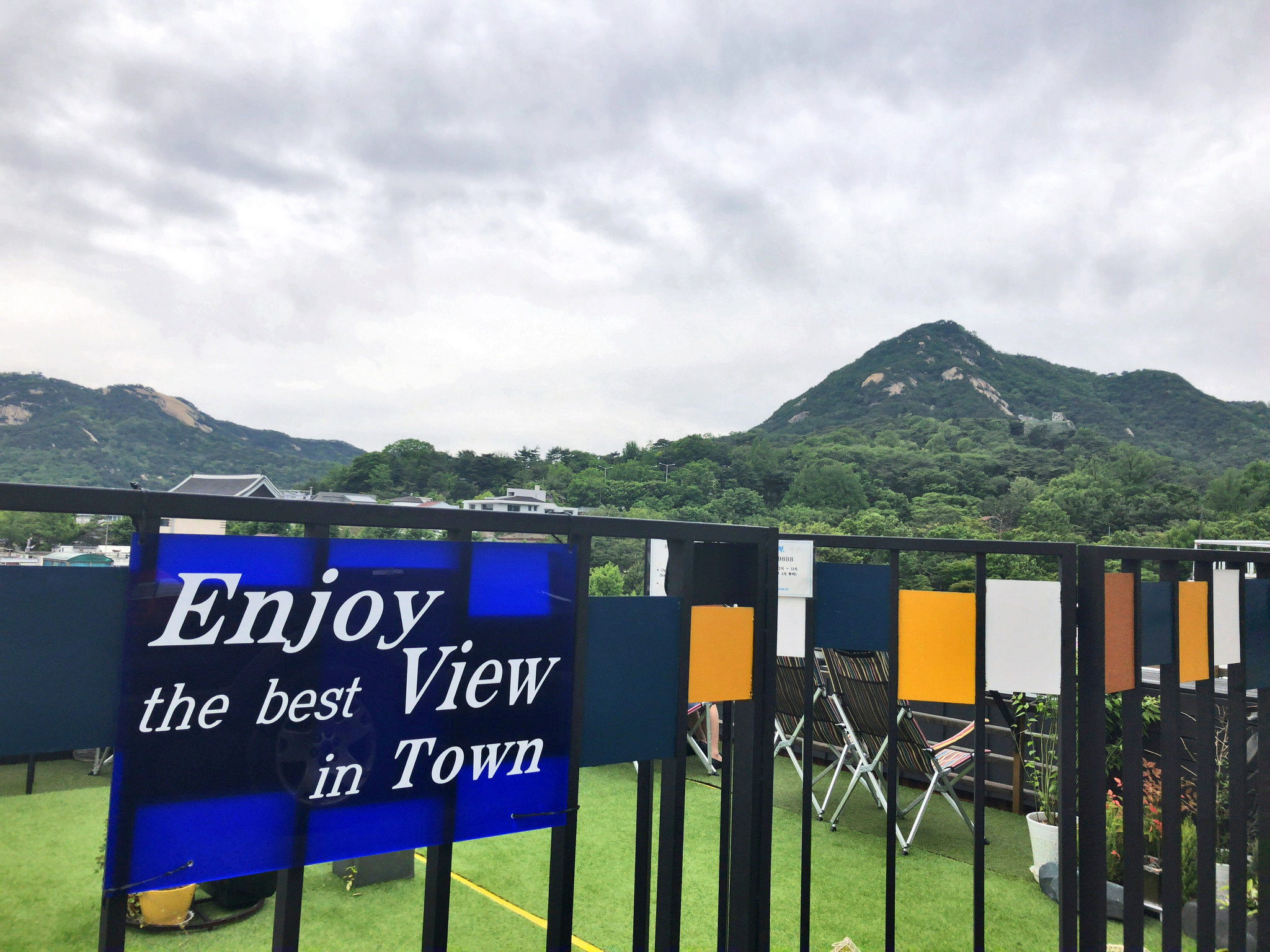 A sign that says 'Enjoy the best View in Town' at Bukchon Hanok Village in Seoul
