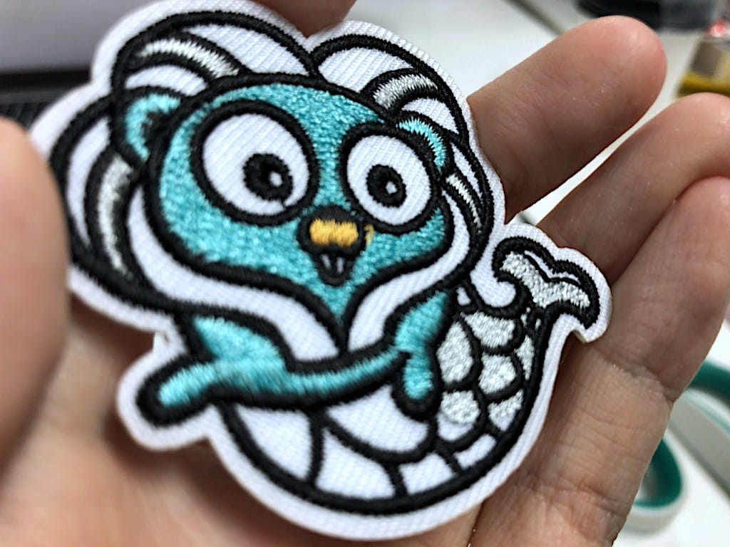 Gophercon Singapore mascot embroidered stickers close-up, from Shenzen Xinbaoyuan Weaving