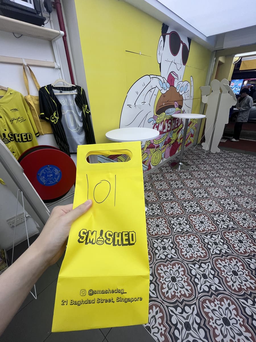 Smashed shop. My hand holding a yellow bag.