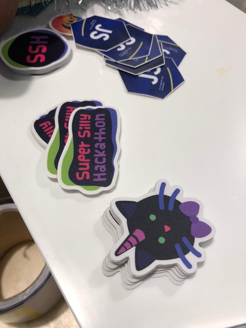 Super Silly Hackathon stickers, one of them is the unicat