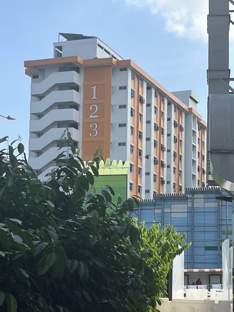HDB block 123, bus-stop and plants, in Singapore