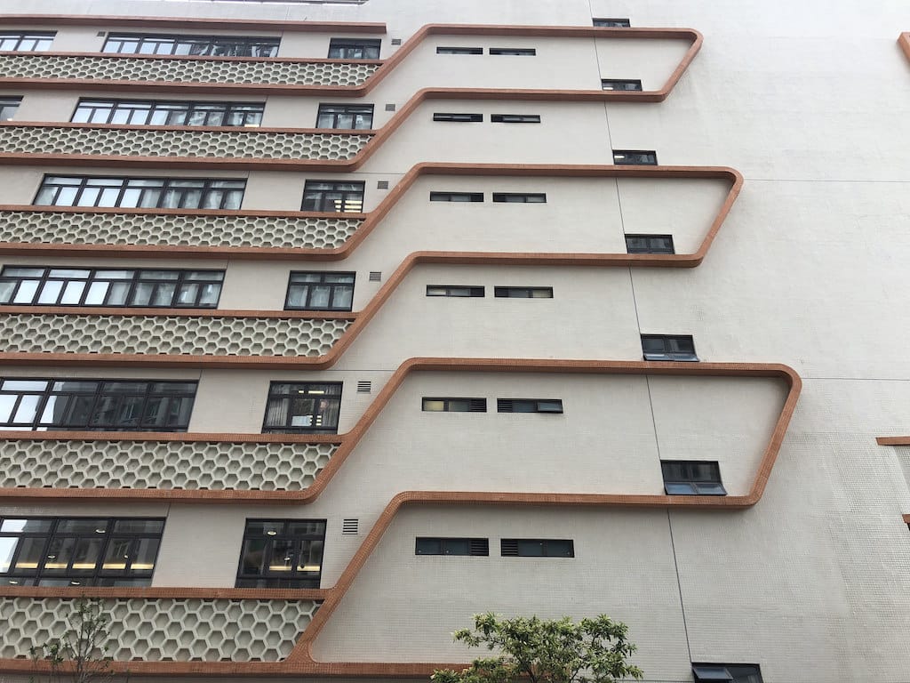 Weird architectural plus honeycomb-pattern structures on a building in Macau